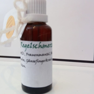 Braunes Tropffläschchen mit roter Pipette und Etikett